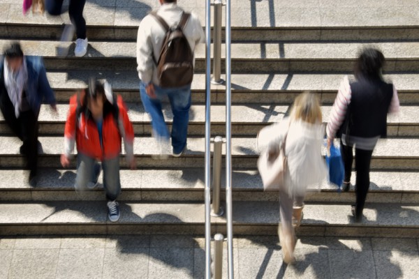 Busy people on subway station steps abstract motion blur. Daily life urban street scene.